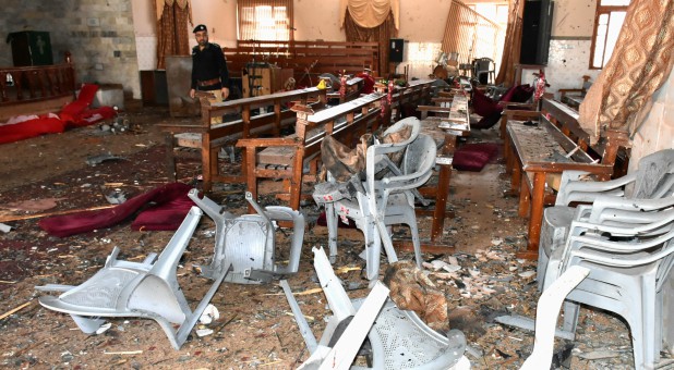 A policeman walks amidst debris and damage after gunmen attacked the Bethel Memorial Methodist Church in Quetta.