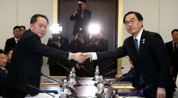 Head of the North Korean delegation, Ri Son Gwon shakes hands with South Korean counterpart Cho Myoung-gyon.