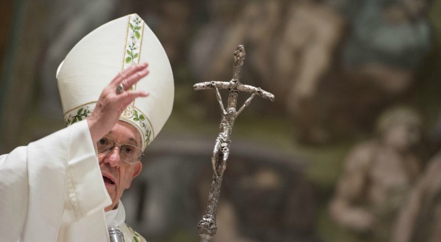 Pope Francis blesses during a solemn Mass in the Sistine Chapel at the Vatican.