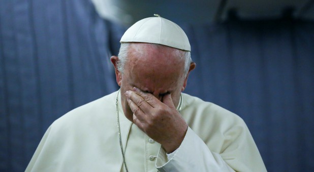 Pope Francis gestures during a news conference on board the plane during his flight back from a trip to Chile and Peru.