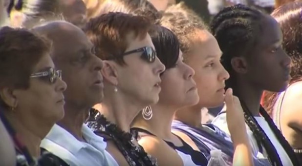 Mourners gather to pray.