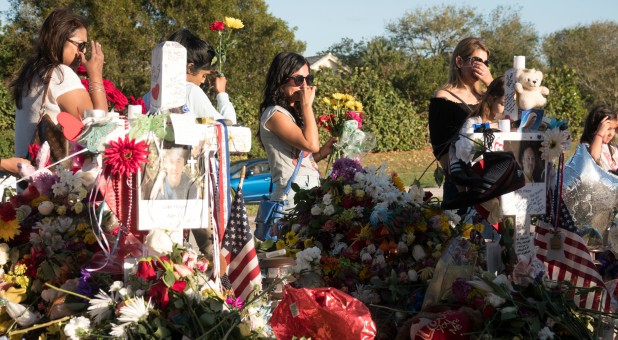 Well-wishers place mementos the day students and parents arrive for voluntary campus orientation at the Marjory Stoneman Douglas High School.