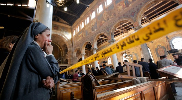 A nun cries as she stands at the scene inside Cairo's Coptic cathedral, following a bombing in Egypt, Dec. 11, 2016.