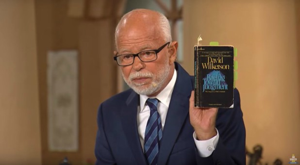 Jim Bakker holds up his copy of David Wilkerson's