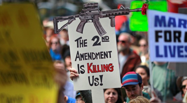 A protester holds up a sign at the March for Our Lives event in Sacramento.