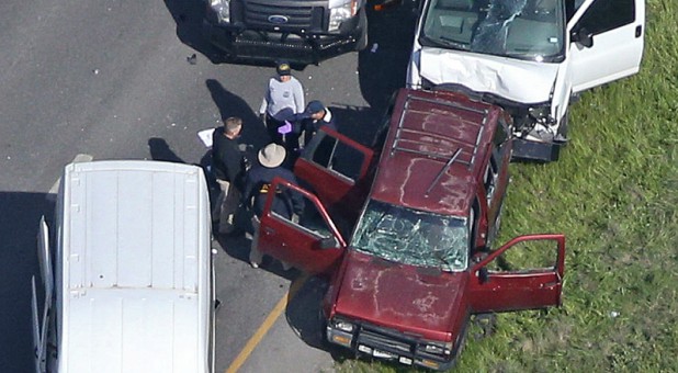 Law enforcement personnel investigate the scene where the Texas bombing suspect blew himself up on the side of a highway north of Austin in Round Rock, Texas.