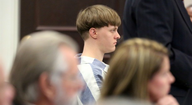 The sister of avowed white supremacist Dylann Roof, who was sentenced to die for the 2015 massacre at a historic South Carolina black church, was arrested for carrying weapons at a high school, according to police officials.