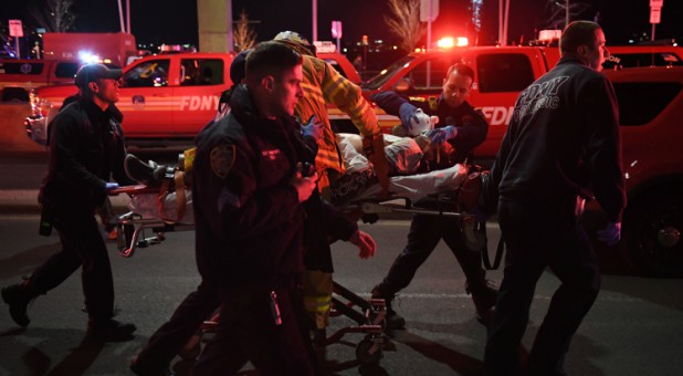 Paramedics and members of the NYFD perform CPR on a victim of a helicopter that crashed into the East River in New York.