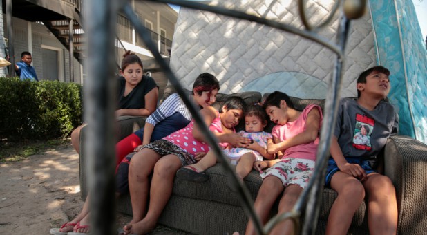 Children watch cartoons outside of their north Houston apartment in the aftermath of Hurricane Harvey in Houston, Texas.