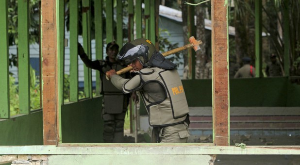 Indonesian civil service police members demolish a church at the Siompin village in Aceh Singkil, Aceh province.