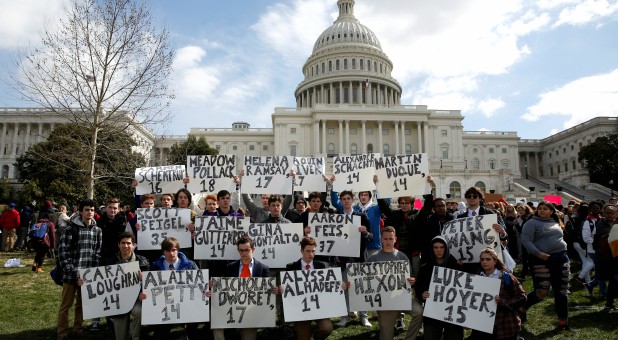 Students from Gonzaga College High School in Washington, DC, hold up signs with the names of those killed in the Parkland, Florida, school shooting during a protest for stricter gun control during a walkout by students at the U.S. Capitol.