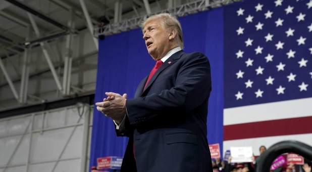 U.S. President Donald Trump claps after speaking in support of Republican congressional candidate Rick Sacconne during a Make America Great Again rally in Moon Township, Pennsylvania.