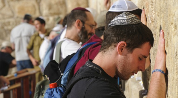 Men pray at the Western Wall.