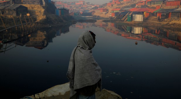 A Rohingya refugee stands next to a pond in the early morning at the Balukhali refugee camp near Cox's Bazar, Bangladesh.