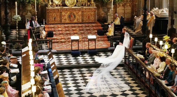 The Duke and Duchess of Sussex, right, listen to Most Rev. Michael Curry, left.