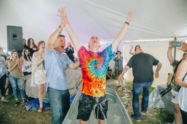 A man praises the Lord after his baptism at Bonnaroo.