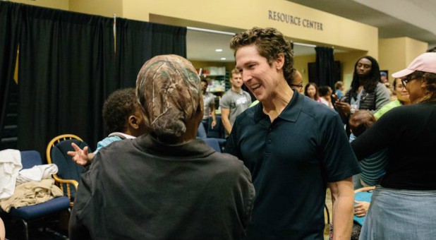 Joel Osteen speaks with those seeking refuge from Hurricane Harvey in 2017.