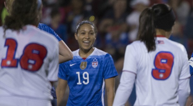 United States defender Jaelene Hinkle (19) and midfielder Carli Lloyd (10) and defender Kelley O'Hara (5) celebrate.