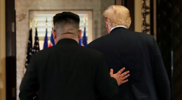 U.S. President Donald Trump and North Korea's leader Kim Jong Un leave after signing documents that acknowledge the progress of the talks and pledge to keep momentum going.