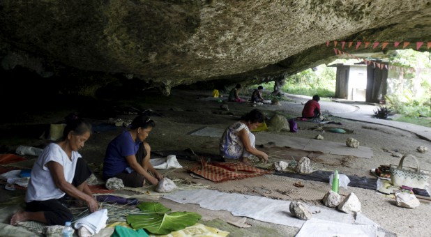 Typhoon Haiyan survivors weave mats at Caub cave in Basey, Samar in central Philippines. The typhoon killed more than 6,000 people in central Philippines.