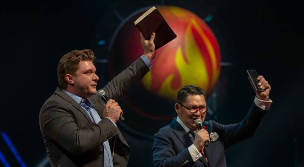 Daniel Kolenda, left, preaches at the Asia congress for Empowered21.