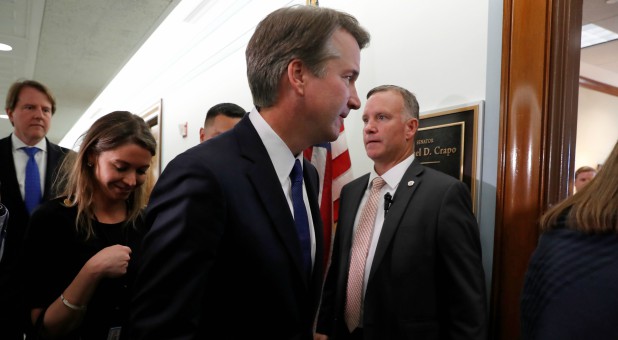 Supreme Court Justice nominee Brett Kavanaugh walks into a meeting.