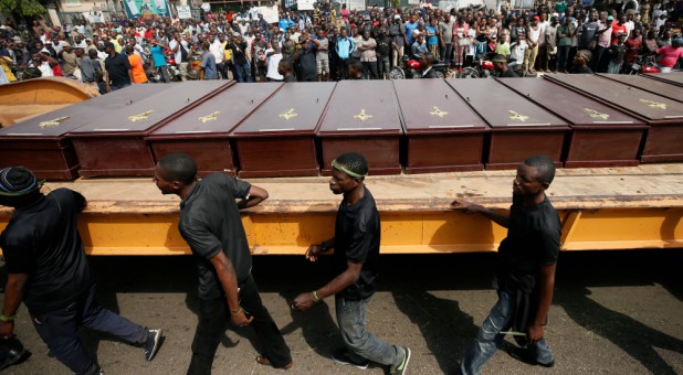 Men march along the truck carrying the coffins of people killed by the Fulani herdsmen, in Makurdi, Nigeria, January 11, 2018.