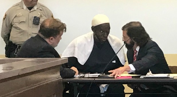 Defense attorney Aleksandar Kostich (R) speaks to defendant Lucas Morton in District Court where Morton and five others accused of child abuse were granted bail in Taos County, New Mexico.