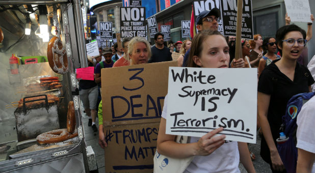 A protester holds a sign reading