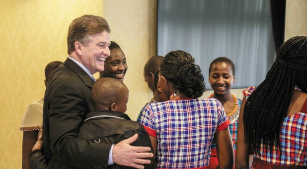 Carter Conlon, far left, visits with some people.