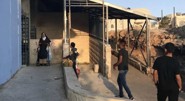 A nun walks through the Hebron Road checkpoint in Bethlehem, West Bank.