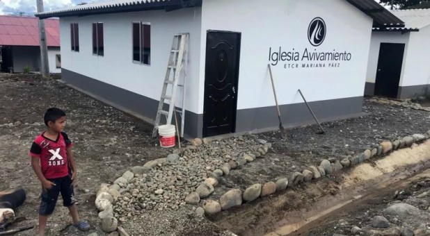 A boy stands outside the community church in the FARC transition zone Mariana Paez near Mesetas, Colombia. The church was built in May 2018 by Avivamiento, a Bogotá-based evangelical church.