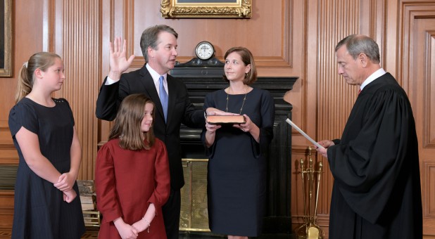 Judge Brett Kavanaugh is sworn in as an associate justice of the U.S. Supreme Court by Chief Justice John Roberts.