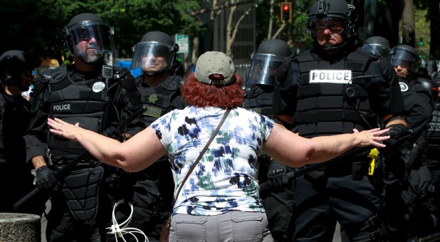 A counter-protester argues with police during a rally by the Patriot Prayer group in Portland, Oregon.