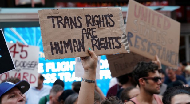 People protest U.S. President Donald Trump's announcement that he plans to reinstate a ban on transgender individuals from serving in any capacity in the U.S. military.