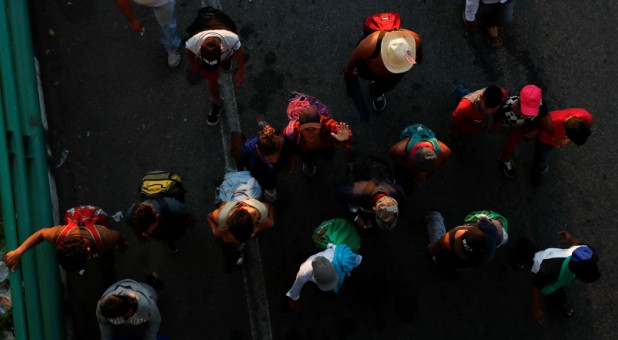 Migrants, part of a caravan traveling to the U.S., walk along the road to Huixtla, near Tapachula, Mexico