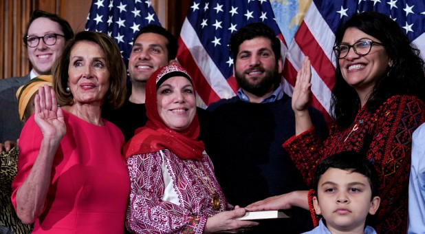 Rep. Rashida Tlaib, D-Mich., poses with Speaker of the House Nancy Pelosi, D-Calif., for a ceremonial swearing-in picture on Capitol Hill.