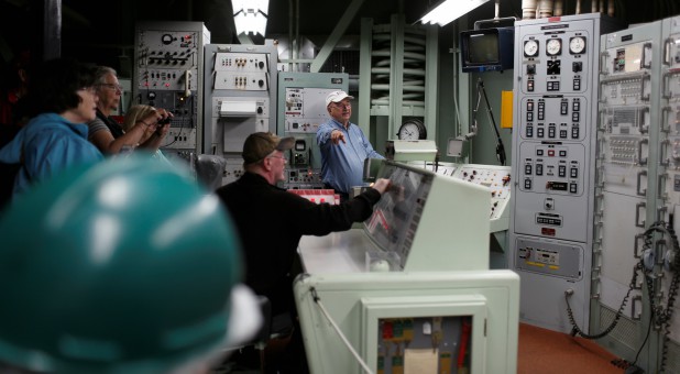 John Gieb demonstrates a missile launch sequence during a tour of the 103-foot Titan II Intercontinental Ballistic Missile (ICBM) site, which was decommissioned in 1982, at the Titan Missile Museum in Sahuarita, Arizona.