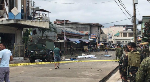 Philippine Army members secure the area outside a church after a bombing attack in Jolo, Sulu province, Philippines.