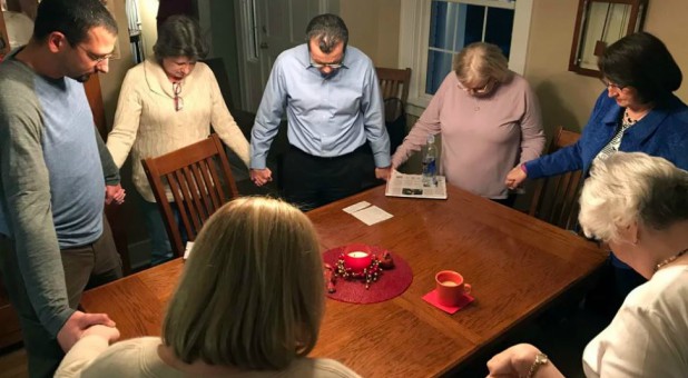 Victims advocate Jimmy Hinton, left, prays with relatives and supporters of victims of Clyde E. Brothers Jr.