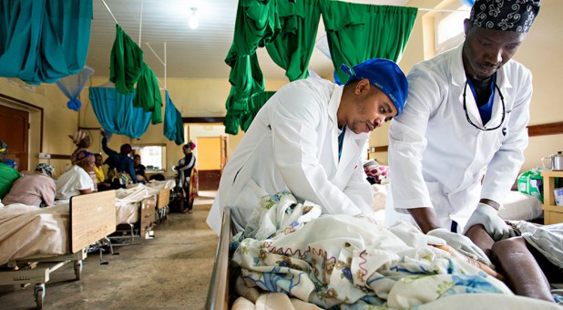 Doctors work with a patient in a field hospital.