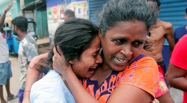 People who live near the church that was attacked yesterday leave their houses as the military try to defuse a suspected van before it exploded in Colombo, Sri Lanka.