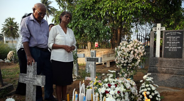 The father and injured mother of Sajuni, 23, who died during a string of suicide bomb attacks on churches and luxury hotels on Easter Sunday, mourn at her funeral.