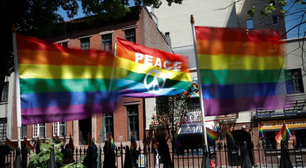 Rainbow flags wave in the wind at the Stonewall National Monument outside the Stonewall Inn.