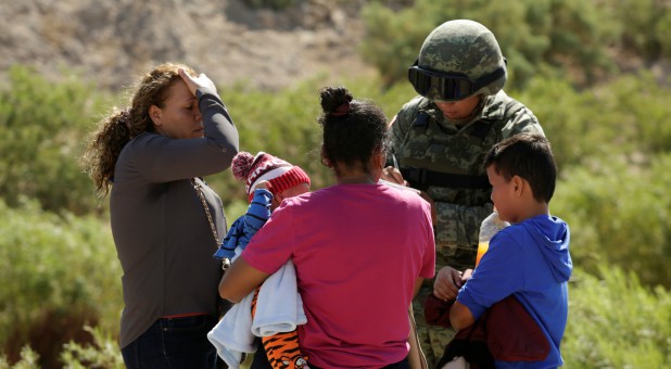 Honduran migrants are stopped by a member of the Mexican National Guard in Anapra, on the outskirts of Ciudad Juarez, Mexico.