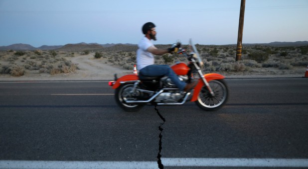 A fault line crack in Highway 178 is opened by a powerful magnitude 7.1 earthquake, triggered by a 6.4 the previous day, near the epicenter in Trona, California.