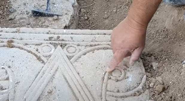 Archaeologist points out detail on the capitals discovered recently from the First Temple period.