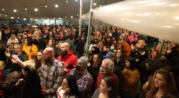 Hundreds respond to an altar call at Murillo's Living Proof tent revival in Bakersfield, California last week.