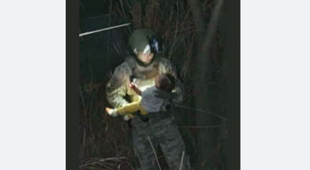 A member of the South Texas Special Operations Group, Texas Rangers Division, holds the baby girl rescued from the Rio Grande