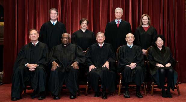 Members of the Supreme Court pose for a group photo at the Supreme Court in Washington